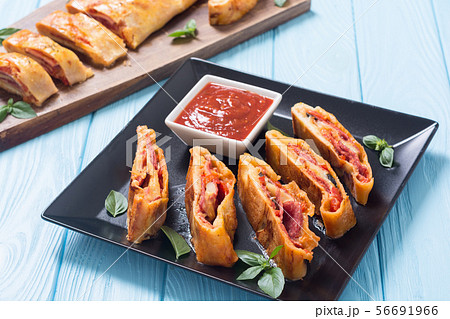 Pizza roll stromboli with cheese salami olives and 56691966