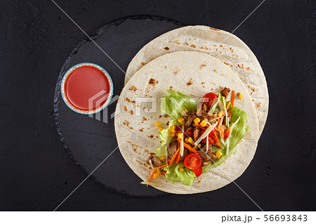 Meat and vegetables wraps. 56693843