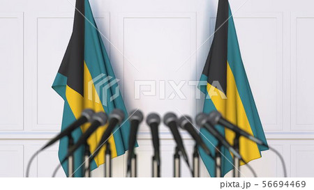 Bahamian official press conference. Flags of the Bahamas and microphones. Conceptual 3D rendering Bahamian official press conference. Flags of the Bahamas and microphones. Conceptual 3D rendering 56694469