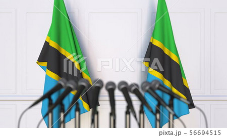 Tanzanian official press conference. Flags of Tanzania and microphones. Conceptual 3D rendering Tanzanian official press conference. Flags of Tanzania and microphones. Conceptual 3D rendering 56694515