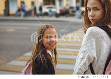 Sisters on city street. Crosswalk Sisters on city street. Crosswalk 56697671