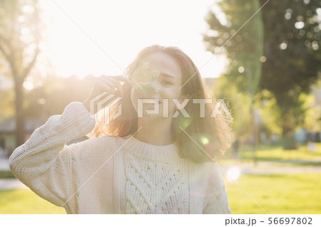 Portrait of teen girl with maple leaf Portrait of teen girl with maple leaf 56697802