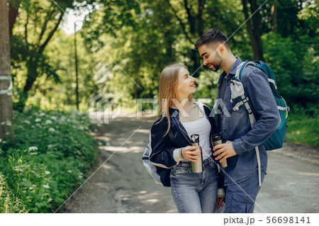 Cute couple have a rest in a summer forest Cute couple have a rest in a summer forest 56698141