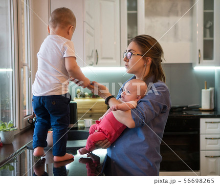 Mother, son and daughter in kitchen 56698265