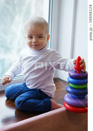 Boy builds tower Boy builds tower 56698328