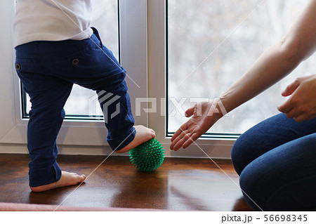 Mother makes foot massage to child. Mother makes foot massage to child. 56698345