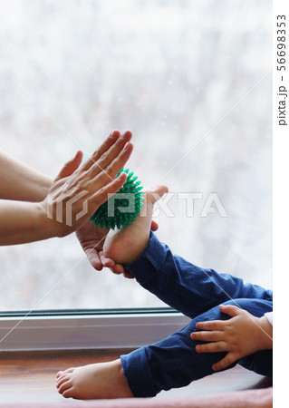 Mother makes foot massage to child. Mother makes foot massage to child. 56698353