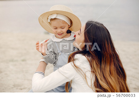 Mother with daughter playing in a summer park 56700033