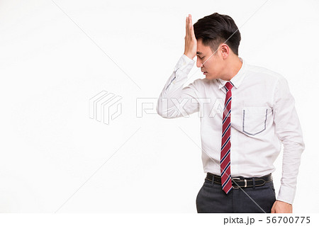 Asian businessman standing and puts hand on head.. 56700775