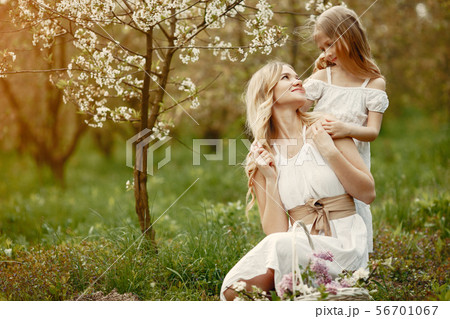 Cute and stylish family in a spring park Cute and stylish family in a spring park 56701067