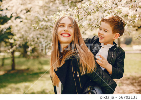 Mother with son playing in a summer park Mother with son playing in a summer park 56702133