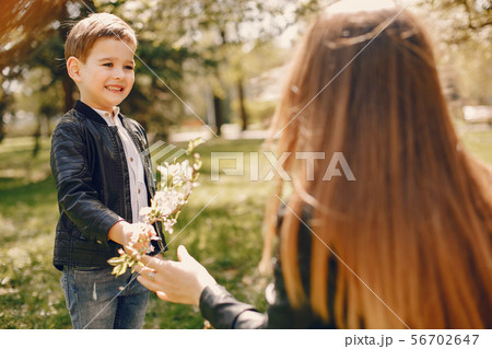 Mother with son playing in a summer park Mother with son playing in a summer park 56702647