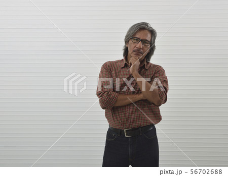 Thoughtful senior businessman in red casual shirt 56702688