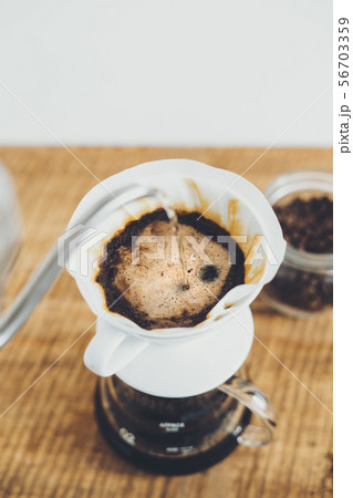 Drip coffee make a cup of coffee On the wood backg Drip coffee make a cup of coffee On the wood backg 56703359