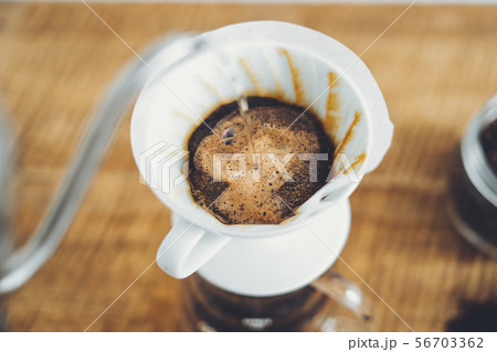 Drip coffee make a cup of coffee On the wood backg Drip coffee make a cup of coffee On the wood backg 56703362