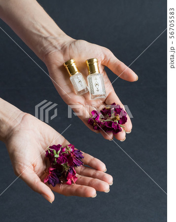 Concentrated perfume in a mini bottle in the hand  56705583