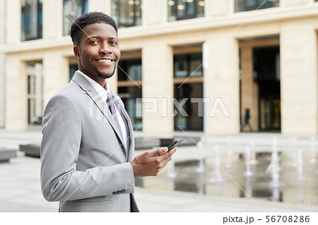Successful businessman with phone Successful businessman with phone 56708286