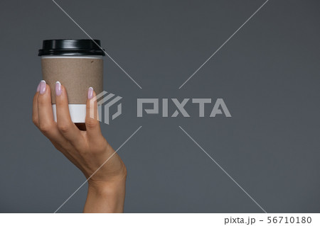 Take Away White Paper Hot Coffee Cup With Right Hand Holding. 56710180