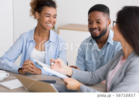 Happy African American Couple Discussing Dream Vacation With Travel Agent Happy African American Couple Discussing Dream Vacation With Travel Agent 56710857