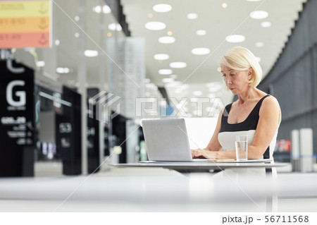 Businesswoman with laptop at business hall Businesswoman with laptop at business hall 56711568