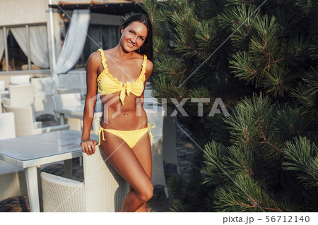 beautiful woman with long in yellow swimsuit on the beach beautiful woman with long in yellow swimsuit on the beach 56712140