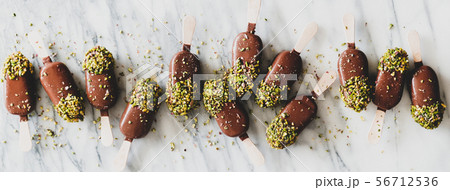 Chocolate glazed ice cream pops with pistachio 56712536