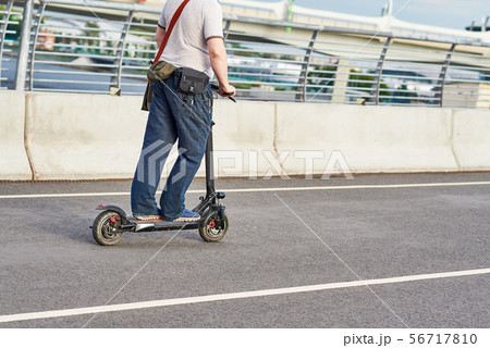 Close up of man driving on electric scooter 56717810