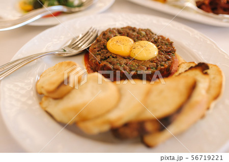 Beef tartare with eggs yolks and toasts. Banquet concept 56719221