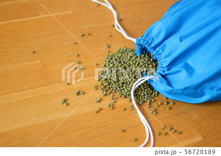 Green mung bean in blue reusable package on wooden background. Eco packaging concept Green mung bean in blue reusable package on wooden background. Eco packaging concept 56720189