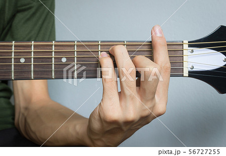 Guitar Player Hand in F Major Chord 56727255