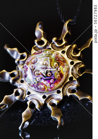 Creative shot of pendant sun made from brass and 56727983