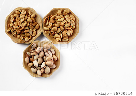 wood plate of salted nuts 56730514