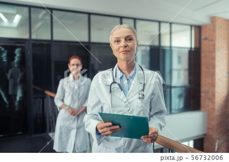 Female doctor with a stethoscope around her neck Female doctor with a stethoscope around her neck 56732006