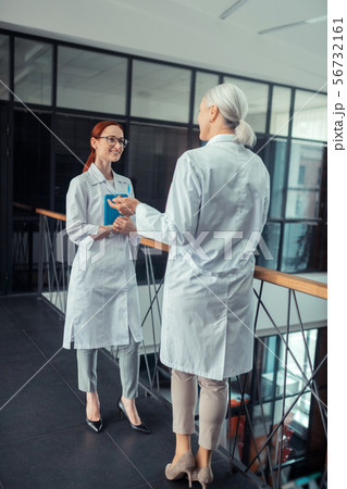 Doctor in a white coat standing in the corridor 56732161