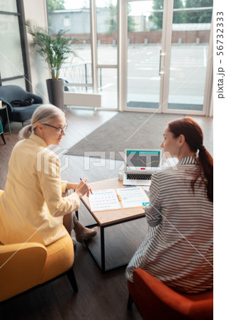 Two businesswomen sitting in front of a laptop 56732333