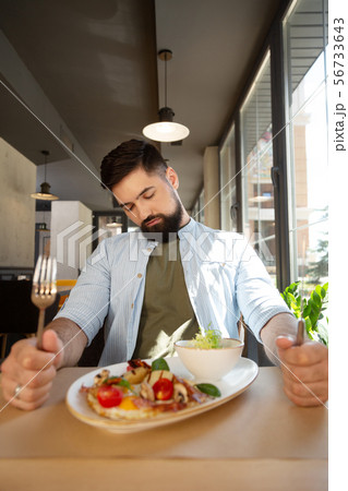Sleepy bearded man wanting to eat in the restaurant Sleepy bearded man wanting to eat in the restaurant 56733643