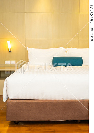Beautiful white pillow and blanket on bed decoration interior Beautiful white pillow and blanket on bed decoration interior 56735423