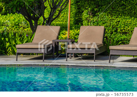 Beautiful umbrella and chair around outdoor swimming pool in hotel resort for holiday vacation travel 56735573