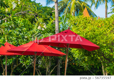 Beautiful umbrella and chair around outdoor swimming pool in hotel resort for holiday vacation travel Beautiful umbrella and chair around outdoor swimming pool in hotel resort for holiday vacation travel 56735597