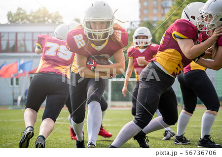 Full-length image of athletes women playing american football on green lawn on summer day Full-length image of athletes women playing american football on green lawn on summer day 56736706