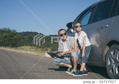 Happy father and son standing near the car at the 56737927