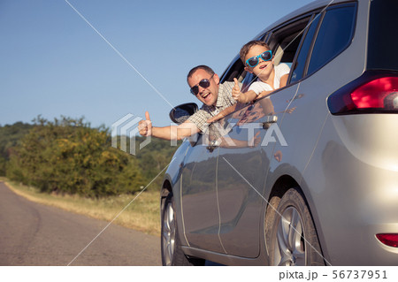 Happy father and son sitting in the car at the day Happy father and son sitting in the car at the day 56737951