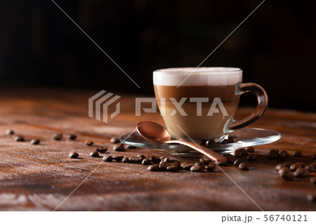 Cup of coffe with milk on a dark background. Hot Cup of coffe with milk on a dark background. Hot 56740121