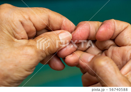 Senior Woman nibbling her nails, Close up & Macro Senior Woman nibbling her nails, Close up & Macro 56740588