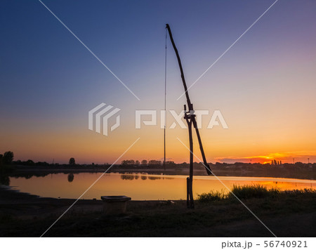 Idyllic rural scene with an old water well 56740921