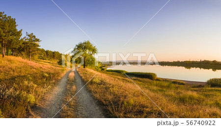 Scenic countryside landscape with rural dirt road 56740922