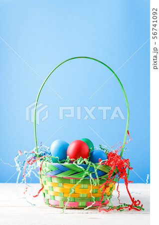 Photo of basket with colorful eggs Photo of basket with colorful eggs 56741092