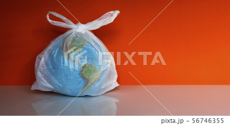 Earth globe in plastic bag on grey background Earth globe in plastic bag on grey background 56746355