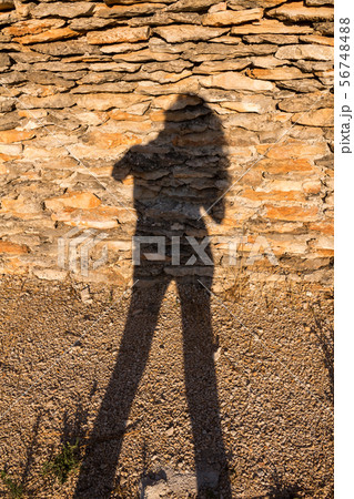 Stone wall with a silhouette of a woman 56748488