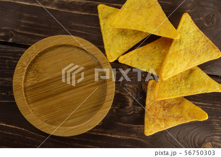 Tortilla cheese chips on brown wood 56750303